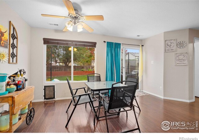 dining space featuring ceiling fan and dark hardwood / wood-style flooring