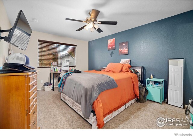 carpeted bedroom with ceiling fan