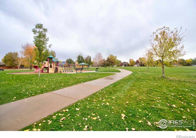 surrounding community featuring a lawn and a playground