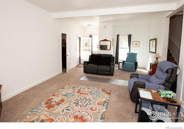 carpeted living room featuring beamed ceiling and a textured ceiling