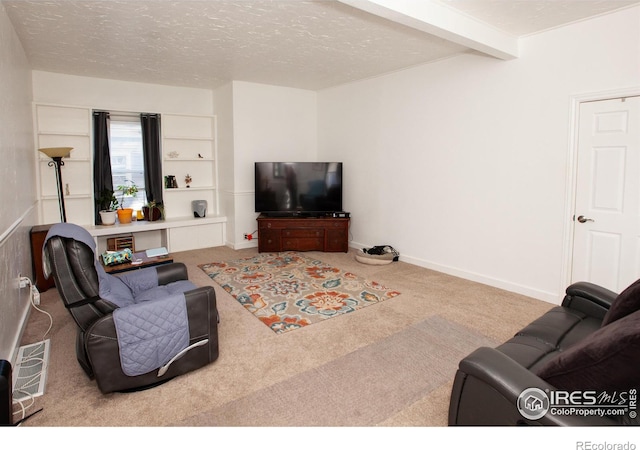 carpeted living room with a textured ceiling and beamed ceiling