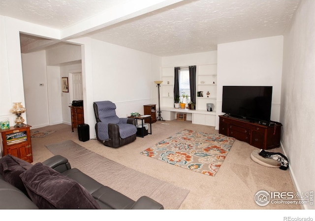 carpeted living room featuring a textured ceiling