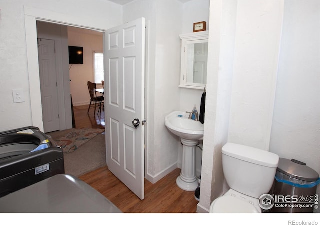 bathroom with toilet and hardwood / wood-style floors