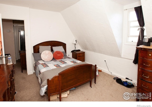 bedroom featuring light carpet and lofted ceiling