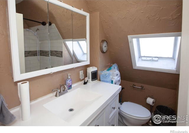 bathroom featuring vanity, toilet, and walk in shower