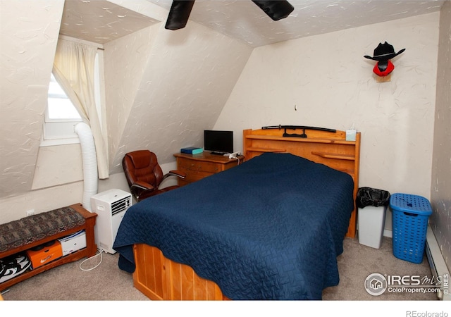 bedroom with lofted ceiling, a textured ceiling, and light colored carpet