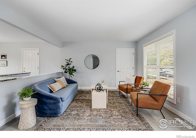 living room featuring beam ceiling and dark hardwood / wood-style flooring