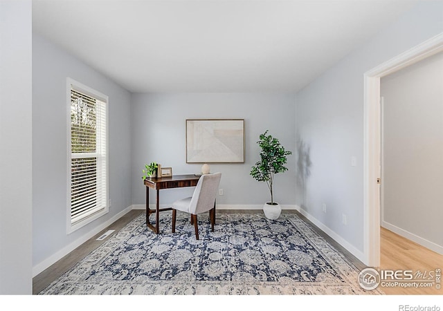 home office with hardwood / wood-style flooring