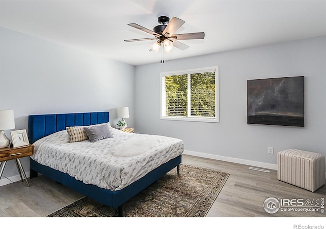 bedroom featuring hardwood / wood-style floors and ceiling fan