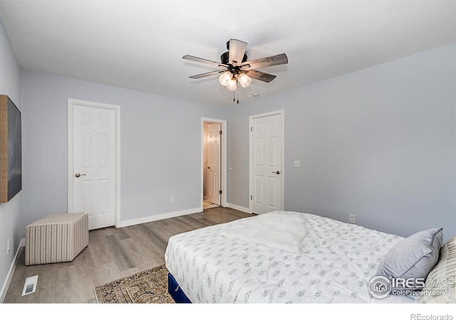 bedroom featuring ceiling fan and dark hardwood / wood-style floors