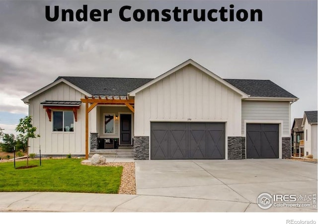 view of front of house with a garage and a front lawn