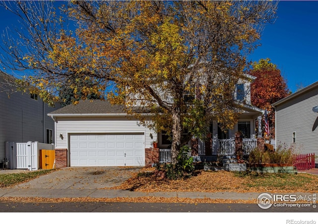 obstructed view of property featuring covered porch and a garage