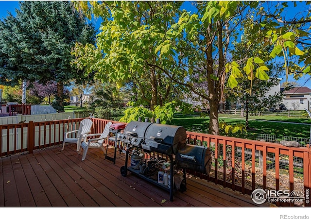 wooden deck with a grill