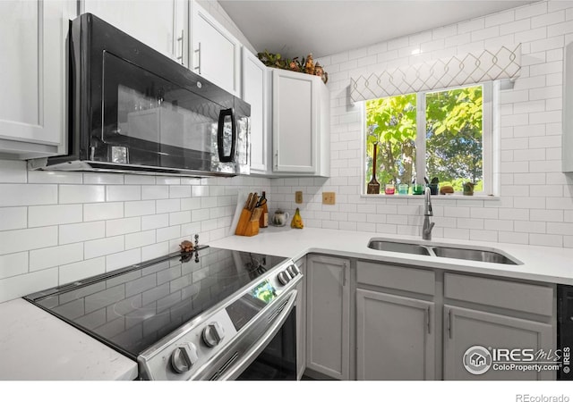 kitchen featuring gray cabinets, sink, electric range, and backsplash