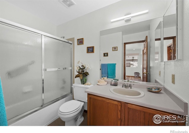 full bathroom featuring vanity, toilet, and enclosed tub / shower combo