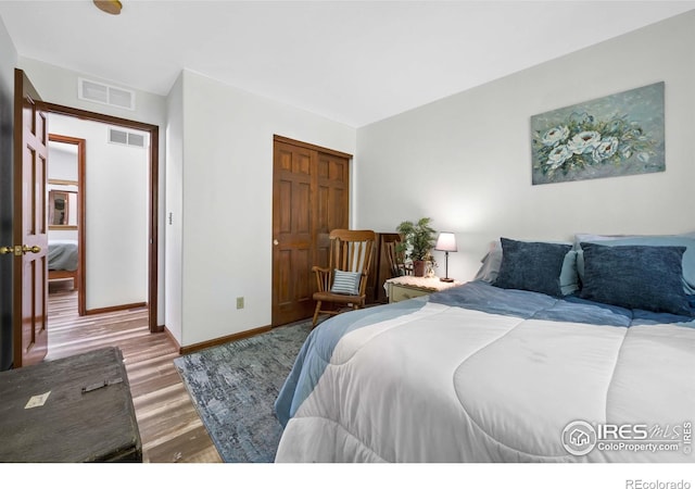 bedroom with hardwood / wood-style flooring and a closet