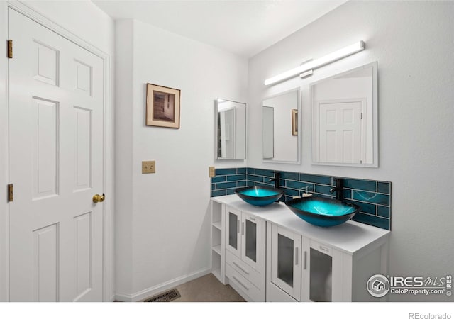 bathroom with vanity and decorative backsplash