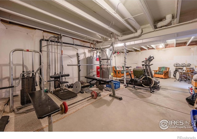 workout area with gas water heater and concrete floors