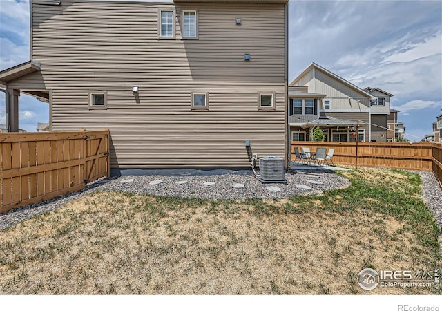 exterior space with a patio, central AC, and a yard