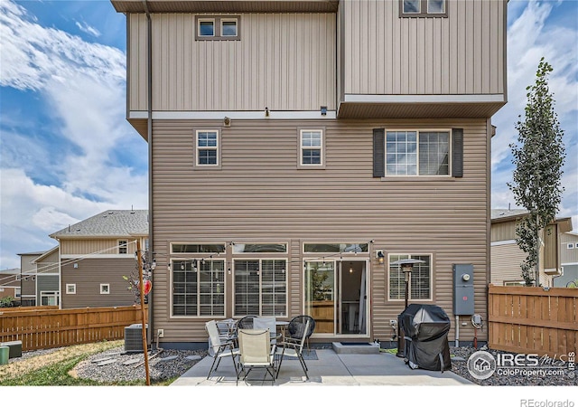 back of property featuring central air condition unit and a patio area