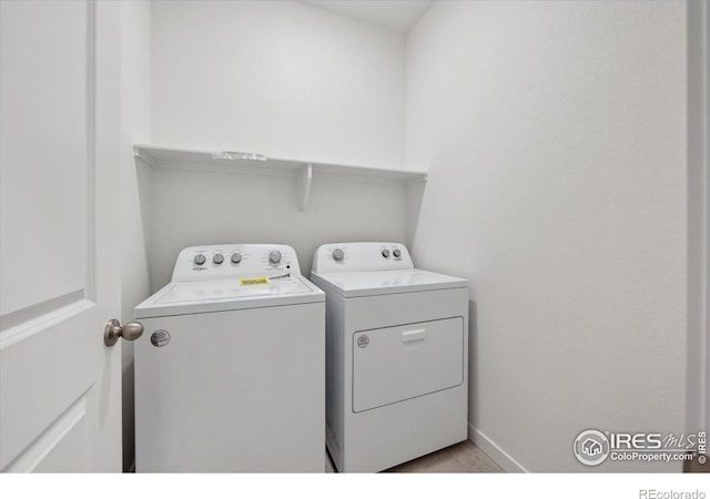 laundry room featuring baseboards, laundry area, and washer and dryer