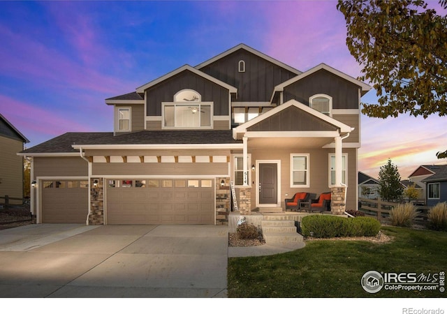 view of front of home featuring a yard, a porch, and a garage