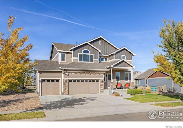 craftsman house featuring a garage and a front lawn