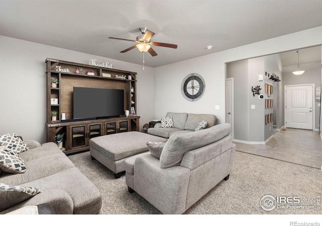 living room featuring ceiling fan and light carpet