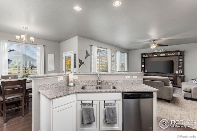 kitchen with sink, dishwasher, plenty of natural light, and white cabinets