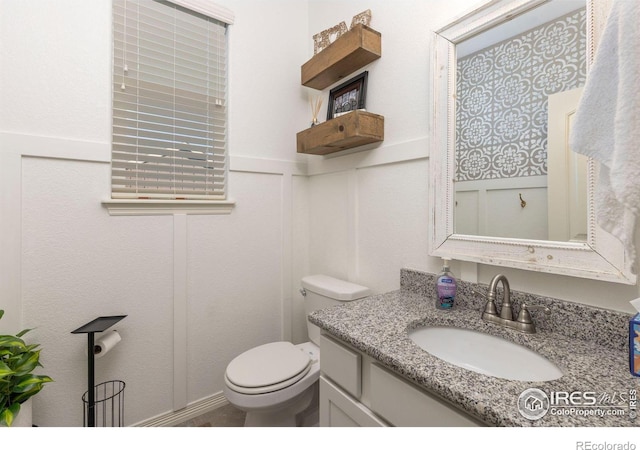 bathroom featuring vanity and toilet