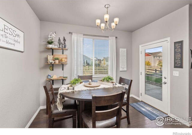 dining area featuring a notable chandelier and dark hardwood / wood-style floors