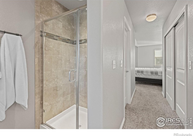 bathroom featuring a textured ceiling and walk in shower