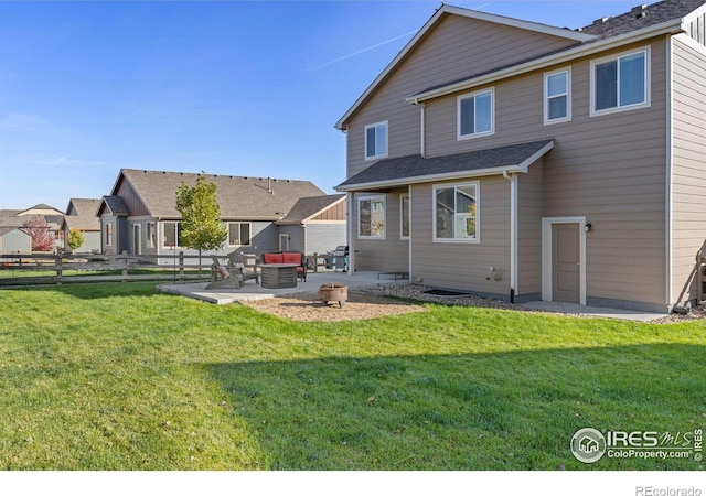 rear view of house featuring a patio, an outdoor fire pit, and a yard