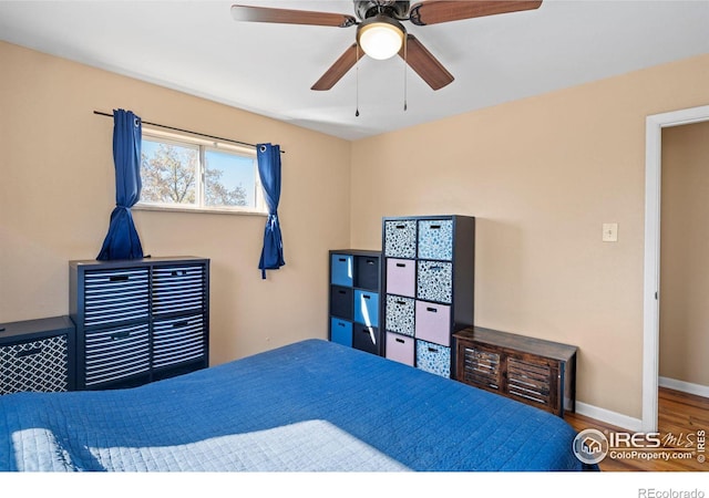 bedroom with hardwood / wood-style flooring and ceiling fan