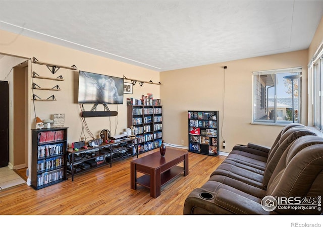 living room with hardwood / wood-style floors and a textured ceiling