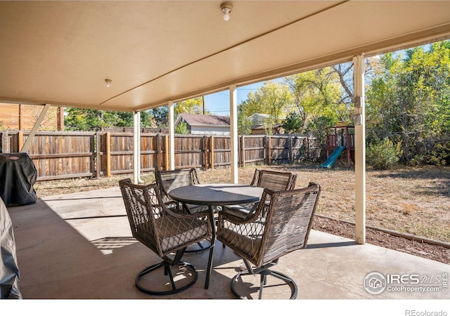 view of patio / terrace featuring a playground and a grill