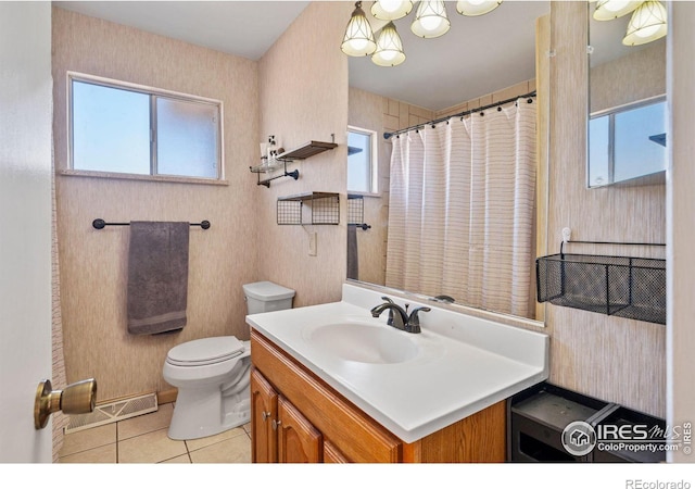 bathroom with vanity, toilet, tile patterned floors, and plenty of natural light