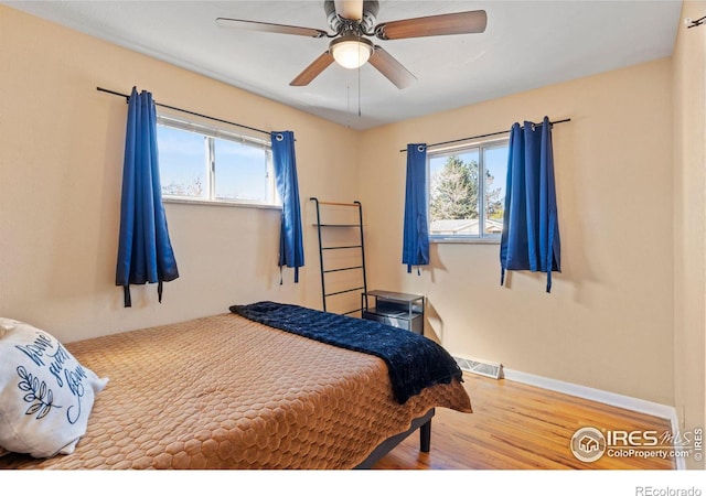 bedroom with wood-type flooring and ceiling fan