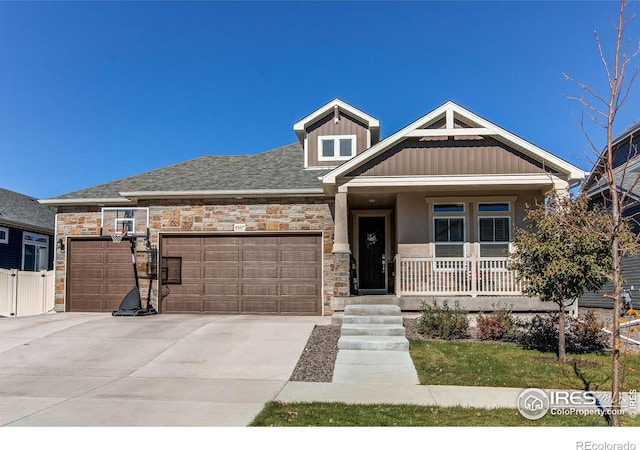 view of front of home featuring a porch and a garage