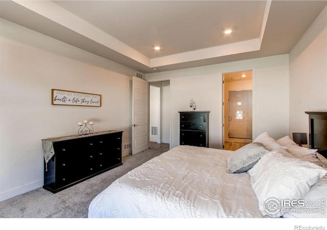 bedroom featuring a raised ceiling and carpet flooring