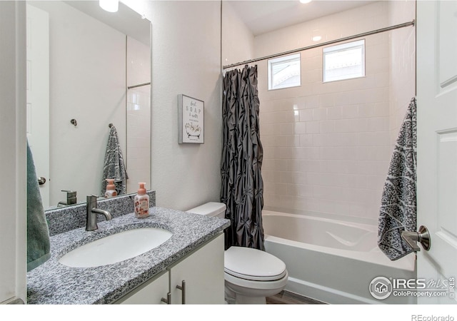 full bathroom featuring vanity, shower / tub combo with curtain, and toilet