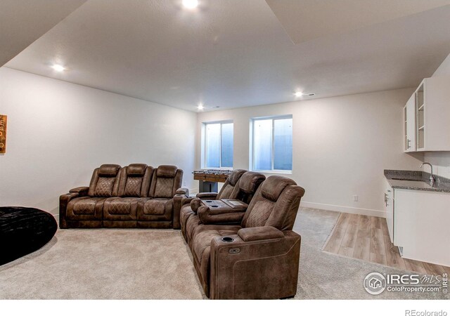 living room featuring sink and light wood-type flooring