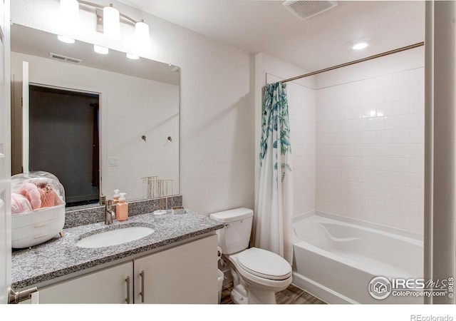 full bathroom with vanity, hardwood / wood-style flooring, toilet, and shower / bathtub combination with curtain