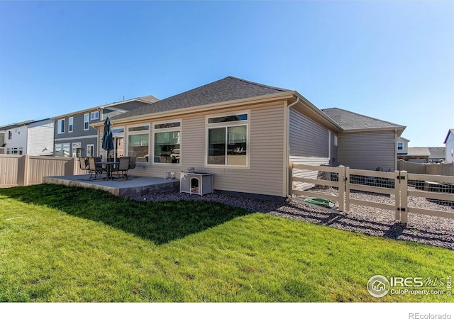 rear view of property featuring a patio area, a yard, and central AC unit