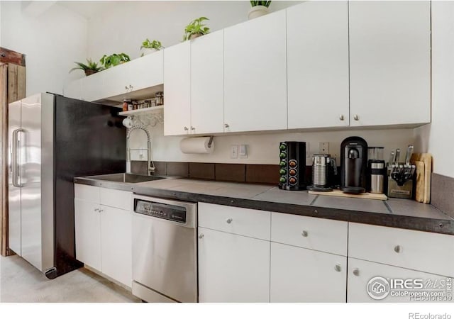 kitchen featuring white cabinetry, appliances with stainless steel finishes, and sink