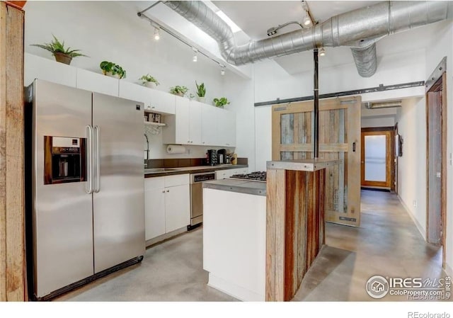 kitchen featuring white cabinetry, a towering ceiling, appliances with stainless steel finishes, and a center island