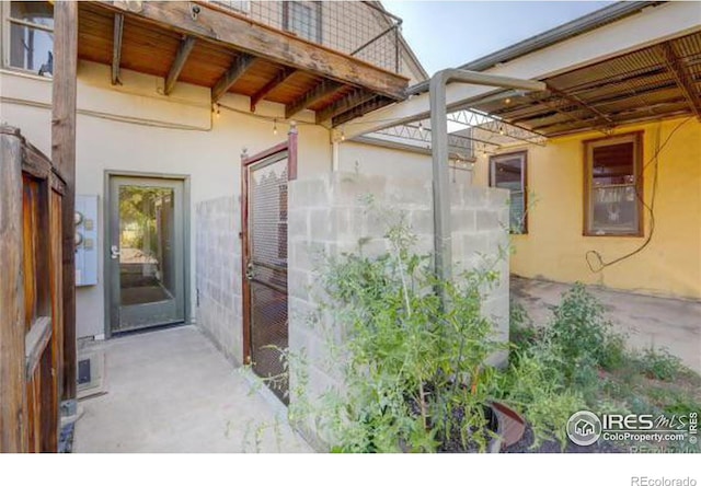 entrance to property with a patio