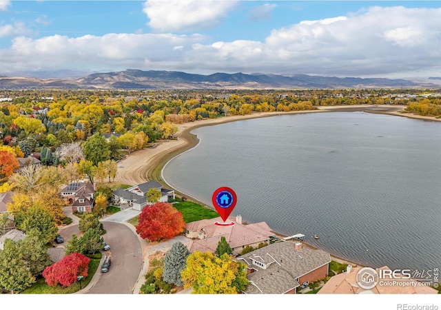 drone / aerial view with a water and mountain view