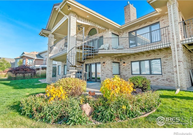 back of property featuring a patio, a lawn, and a balcony