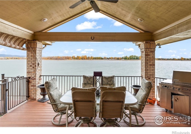 wooden terrace featuring a water view, ceiling fan, and area for grilling